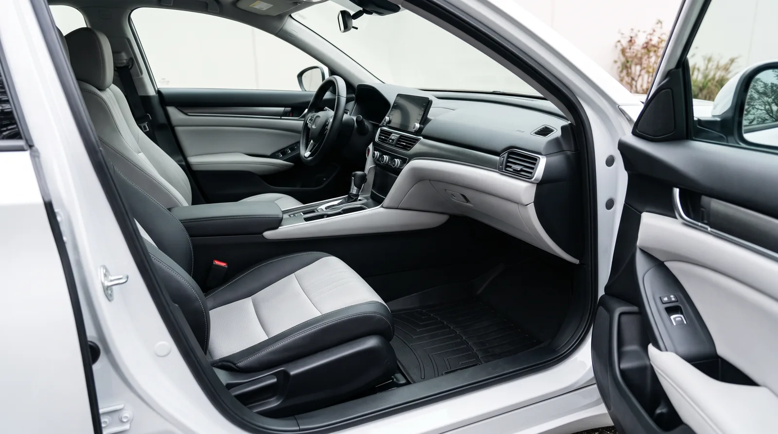 Clean light-gray car interior with black floor mats after a professional interior detail in Opelika AL