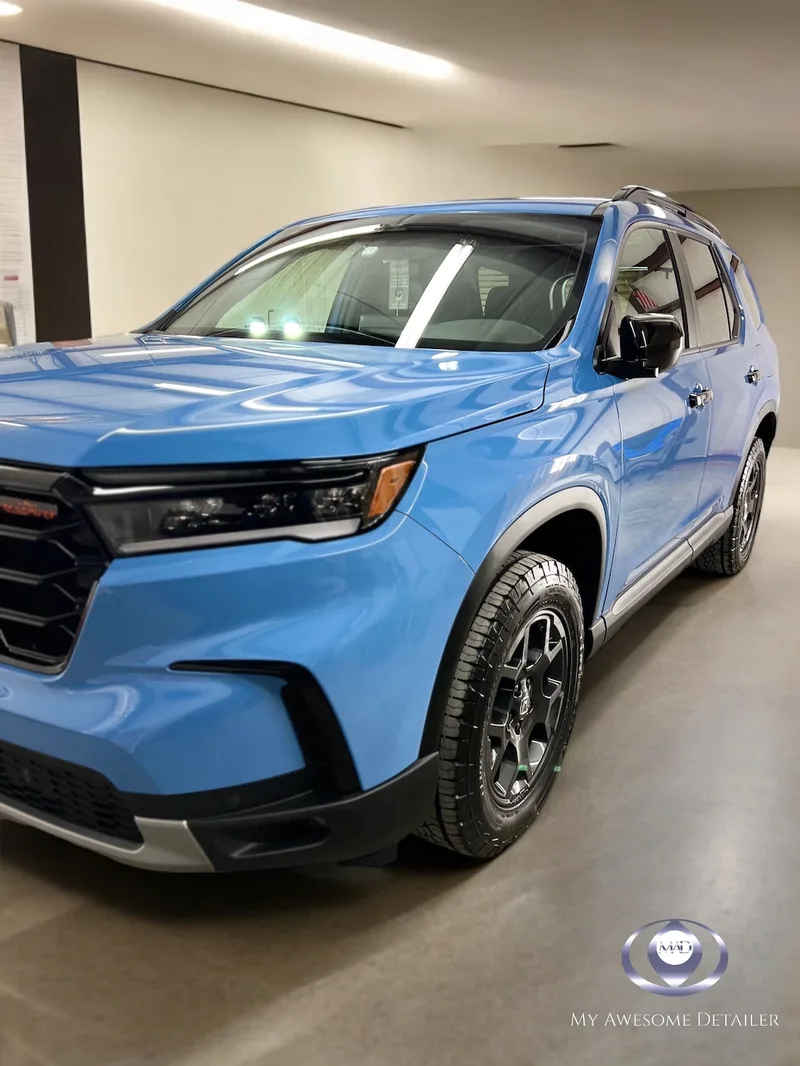 Blue Honda Pilot Trailsport in shop