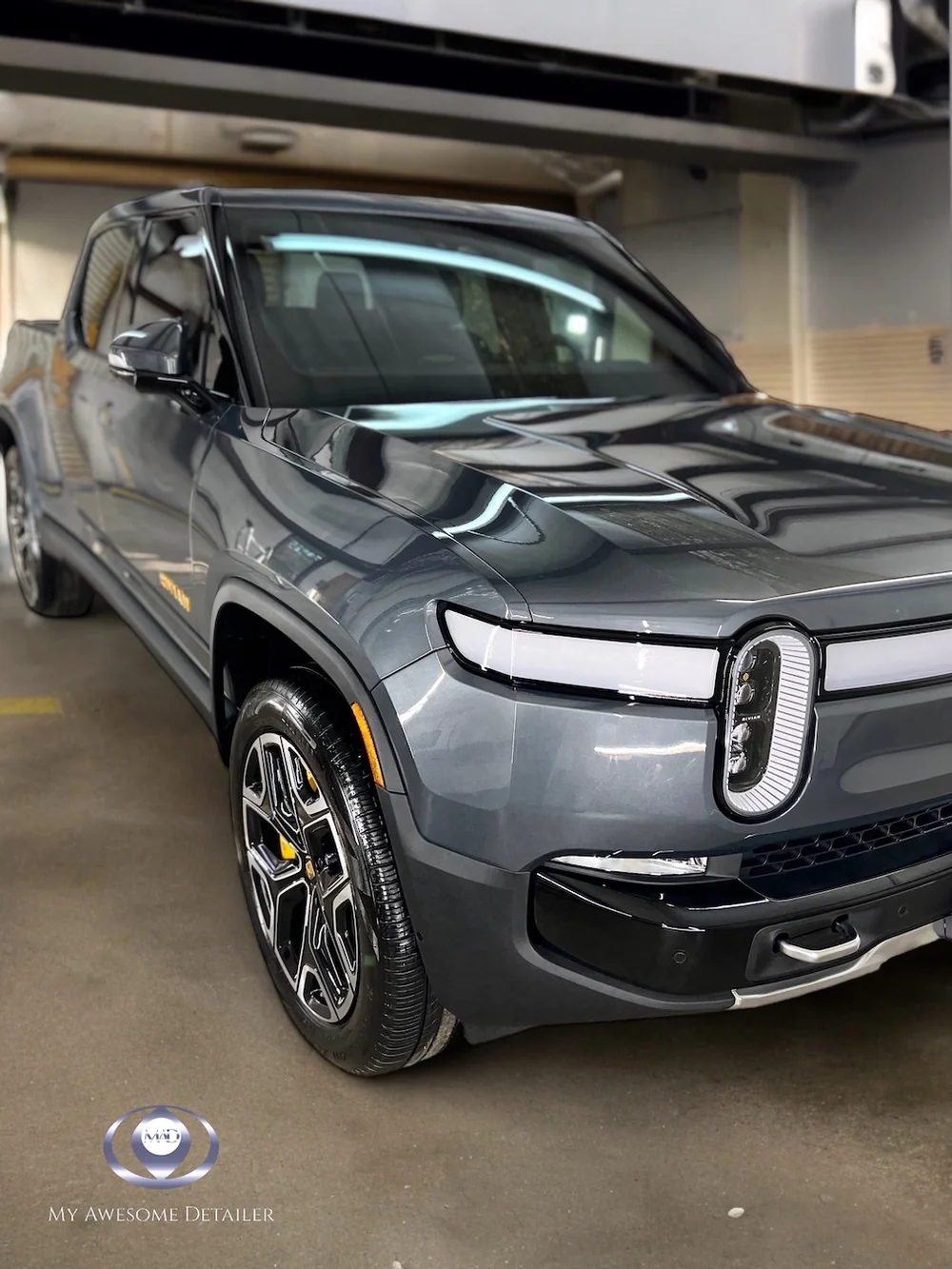 Gray Rivian R1T in garage