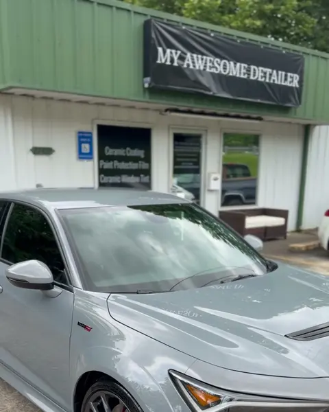 The front of the My Awesome Detailer shop in Opelika: the shop banner, the front door and the window signs for ceramic coating, paint protection film and ceramic window tint