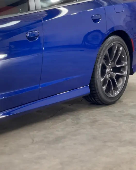 A blue Dodge Charger Scat Pack side in our shop after ceramic coating