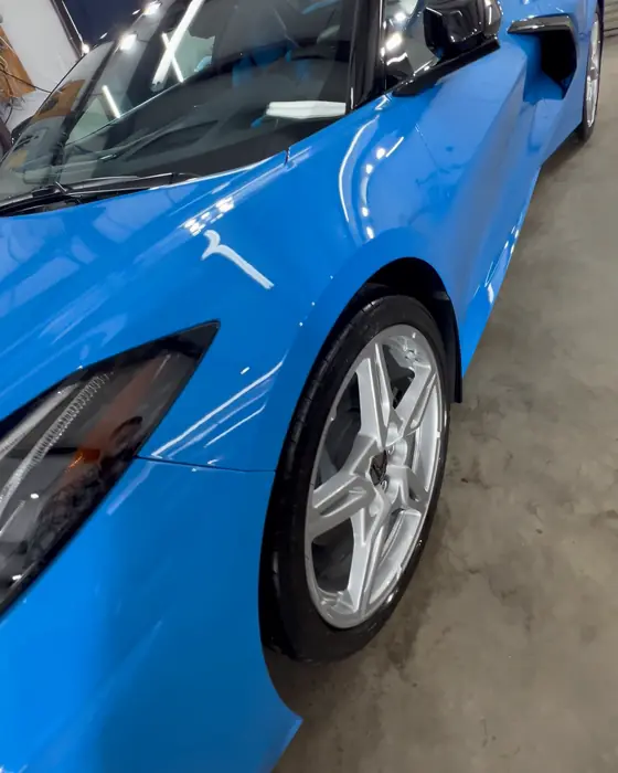 A rapid-blue Corvette C8 front quarter in our shop after ceramic coating