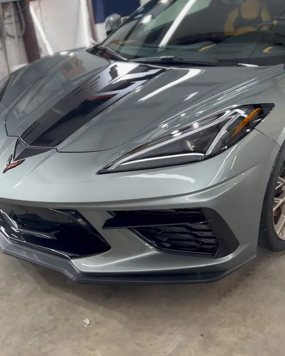 A silver-green Corvette Stingray with bronze wheels in our shop after ceramic coating