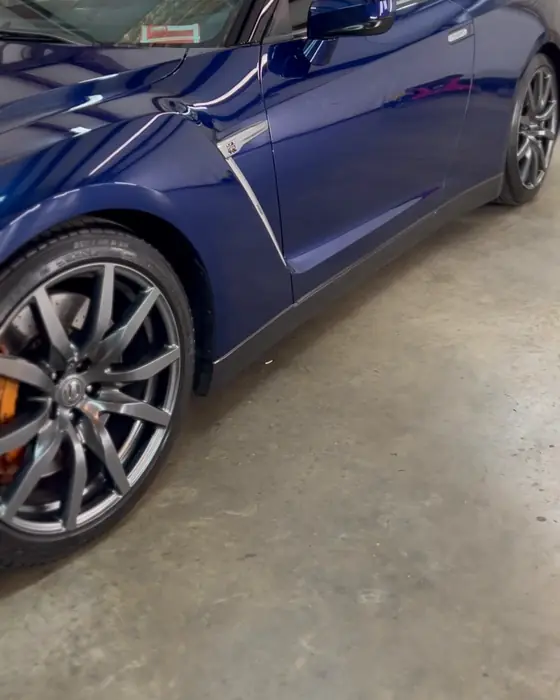 A deep blue Nissan GT-R in our shop after ceramic coating