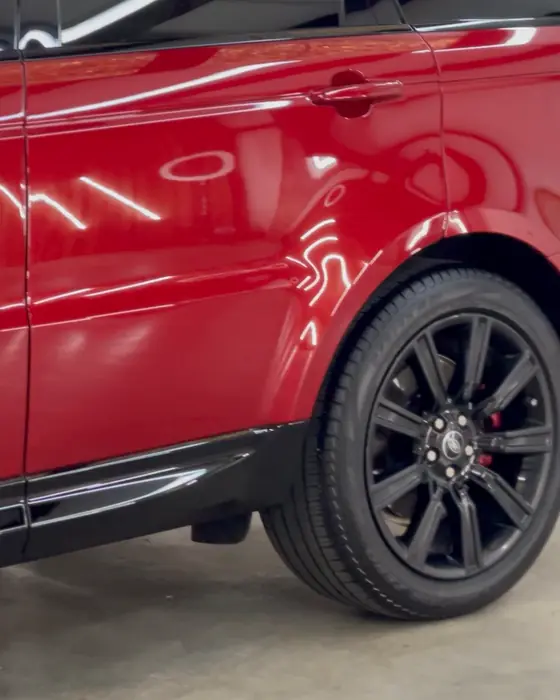A red Range Rover Sport side in our shop after ceramic coating
